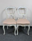 A pair of antique pine white and cream painted chairs