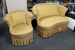 An early twentieth century continental shaped backed settee and chair upholstered in golden fabric