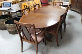 A mahogany G-plan oval extending dining table with leaf and six chairs