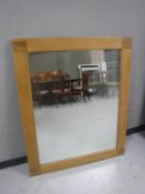 A contemporary oak framed overmantel mirror