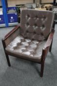 A twentieth century framed beech bergere armchair with brown leather cushions