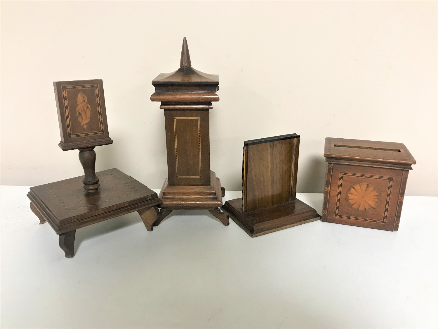 Three pieces of Victorian inlaid mahogany treen to include matchbook holder on stand,