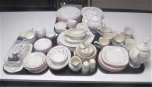 An extensive English floral pottery tea and dinner service with matching cutlery