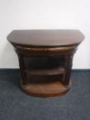 A continental mahogany three tier side table fitted a drawer with column supports