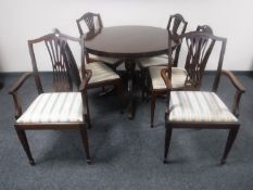 A circular inlaid mahogany Regency style extending dining table with leaf together with six chairs