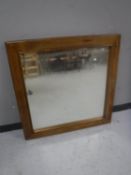 A contemporary pine framed square mirror