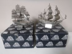 Two boxed metal sailing ships,