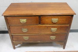 An Edwardian mahogany four drawer chest with brass drop handles