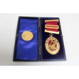 A gilt and enamelled Masonic Durham medal and a silver-gilt Masonic medallion