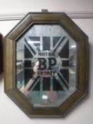 An octagonal framed mirror bearing B.P.