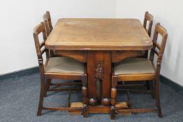 A 1930's oak pull out table and four chairs