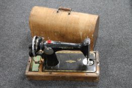 A mid 20th century oak cased Singer hand sewing machine