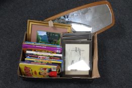 A box containing assorted children's annuals, framed Brian Lewis prints of Bamburgh,