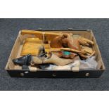 A box containing vintage wooden shoe stretchers,