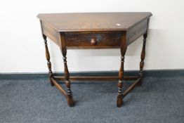 A shaped oak hall table fitted with a drawer