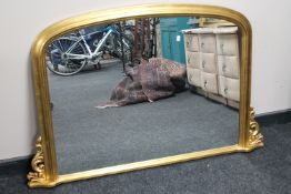 A Victorian style arched topped gilt overmantel mirror
