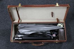 A vintage leather case containing cameras accessories including tripods,