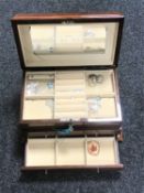 A high gloss jewellery box with key containing a small quantity of silver jewellery