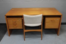 A teak Chapmans Siesta twin pedestal writing desk together with Siesta teak armchair