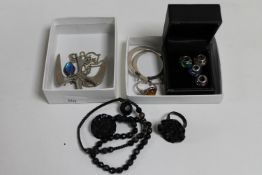 Two boxes of silver jewellery : charms, butterfly wing pendant on chain, silver and amber ring,