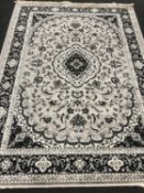 A Keshan rug on grey ground,