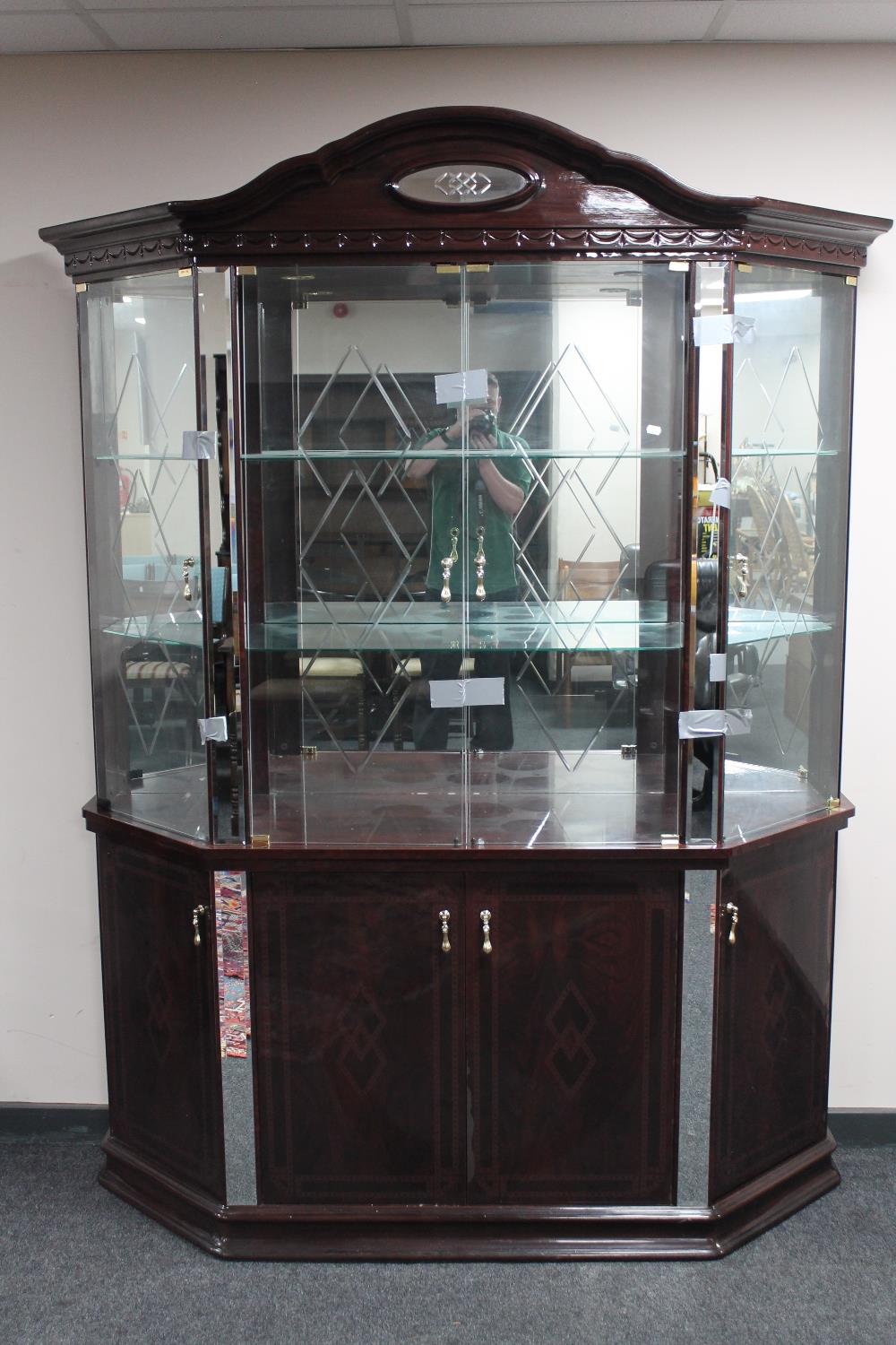 An Italianate high gloss four door display cabinet fitted with cupboards