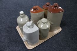 A tray containing six antique glazed pottery foot warmers