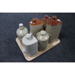 A tray containing six antique glazed pottery foot warmers