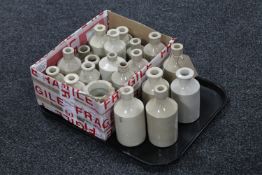 A tray containing twenty approximately antique cream stoneware bottles and jars