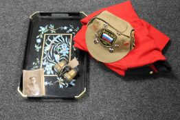 A tray containing a military formal tunic, a Russian cap bearing pin badges,