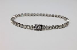 A 14ct white gold diamond tennis bracelet, featuring 42 round brilliant cut white diamonds 3.47ct.