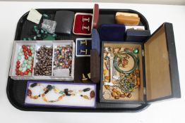 A tray of assorted costume jewellery : polished stone necklaces, dress rings,