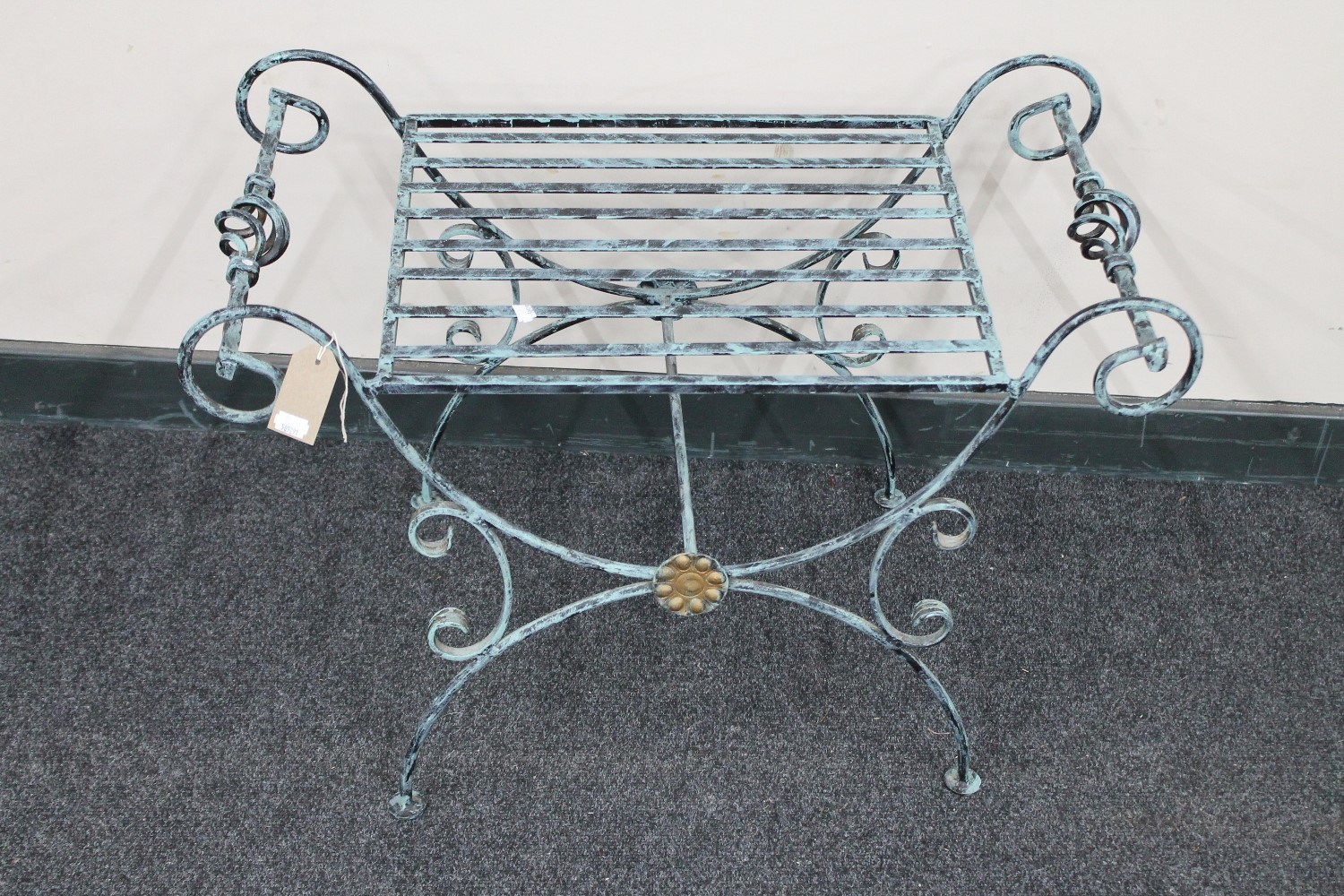 A wrought metal dressing table stool