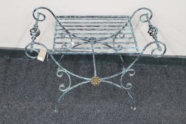 A wrought metal dressing table stool