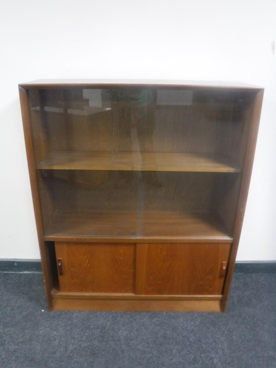 Two sets of mid 20th century teak sliding door bookshelves from the Herbert E.