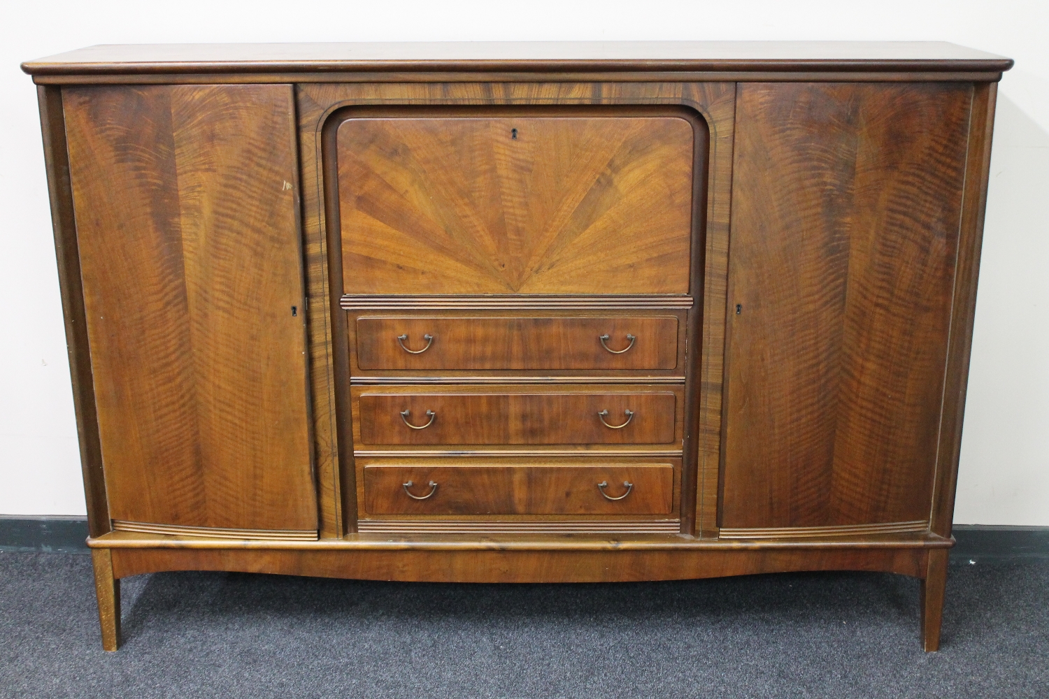 A mid 20th century continental walnut cocktail sideboard