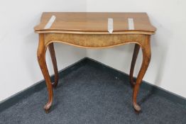 A late 19th century continental walnut turnover top tea table on cabriole legs