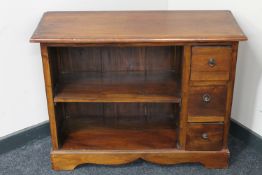 A set of Eastern hardwood open bookshelves fitted three drawers