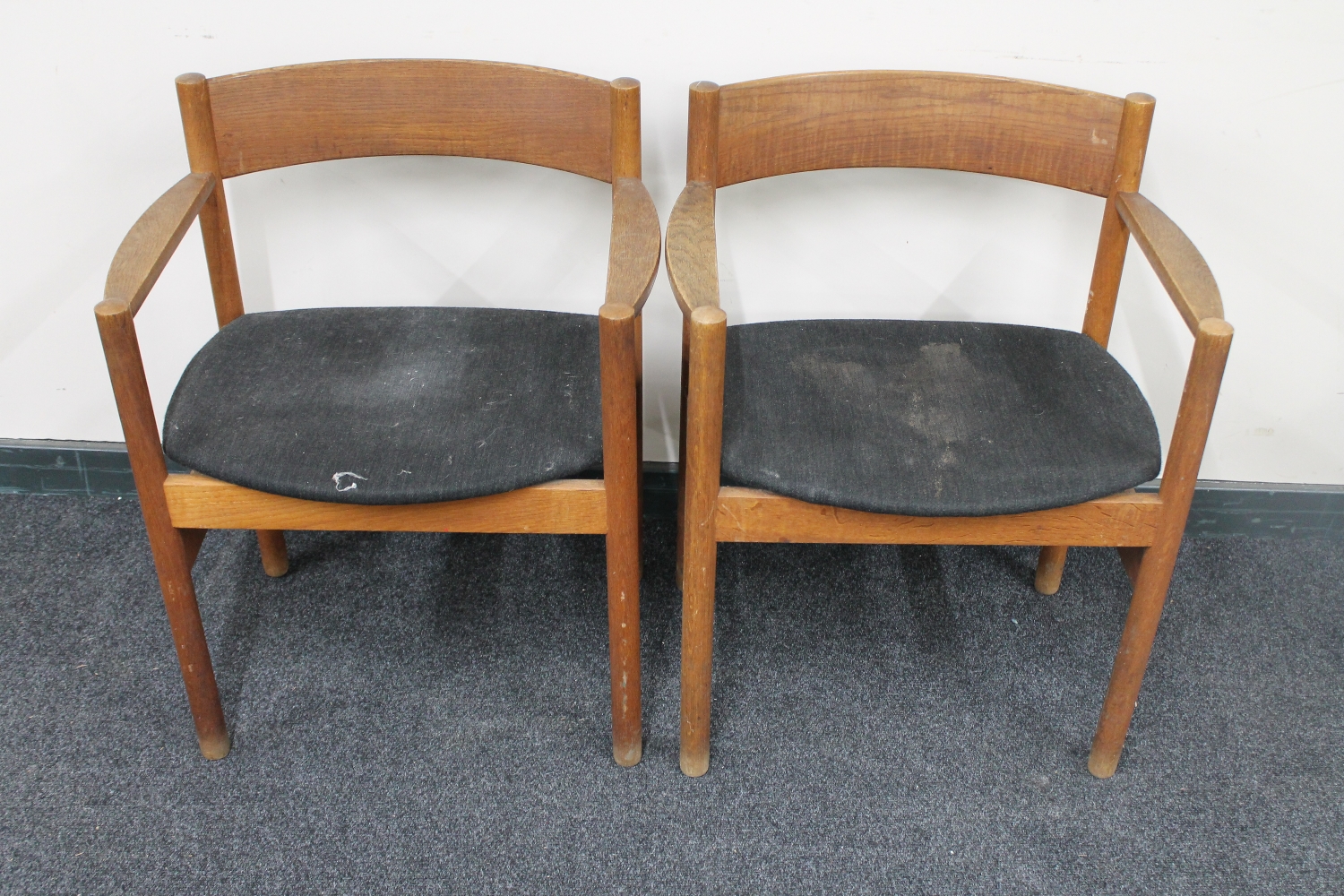 A pair of mid 20th century teak armchairs