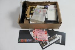 A box of a quantity of loose stamps and first day covers