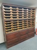 An early twentieth century haberdashery chest fitted with sixty sliding drawers and a further six