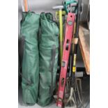 A set of aluminium extension ladders together with a bundle of garden tools,