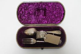 A cased silver fork and spoon with napkin ring,