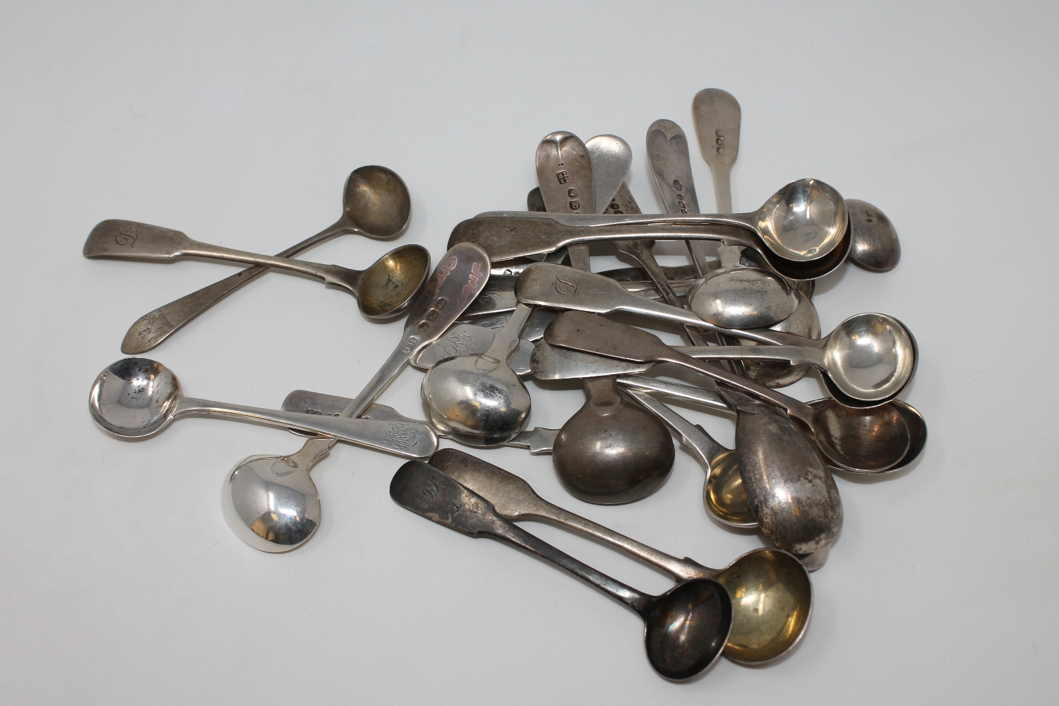 A collection of twenty-four Georgian and later silver salt and mustard spoons