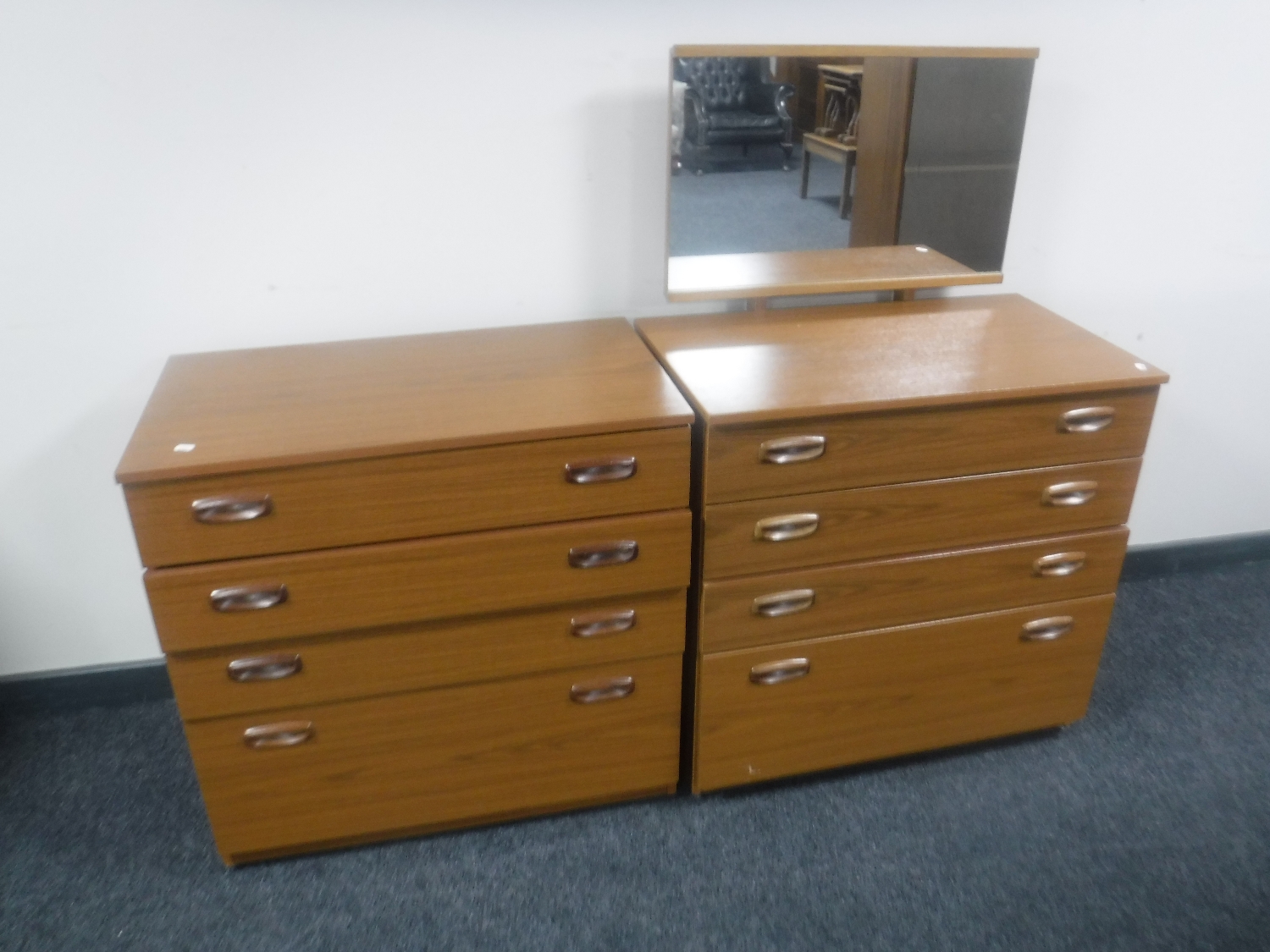 A Shrieber teak four drawer dressing chest together with matching four door chest