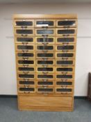 An early twentieth century haberdashery multi drawer chest fitted with thirty drawers and tambour
