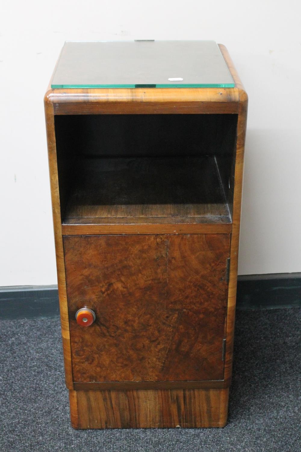 A 1930's figured walnut bedside cabinet