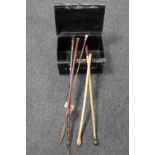 An early 20th century metal deed box containing a swagger stick,