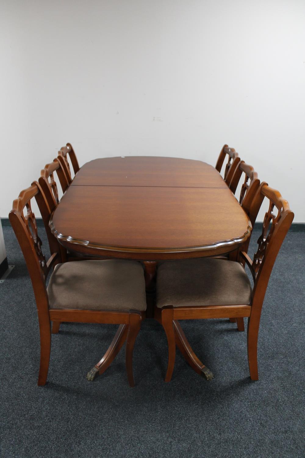 A reproduction extending pedestal table with six chairs