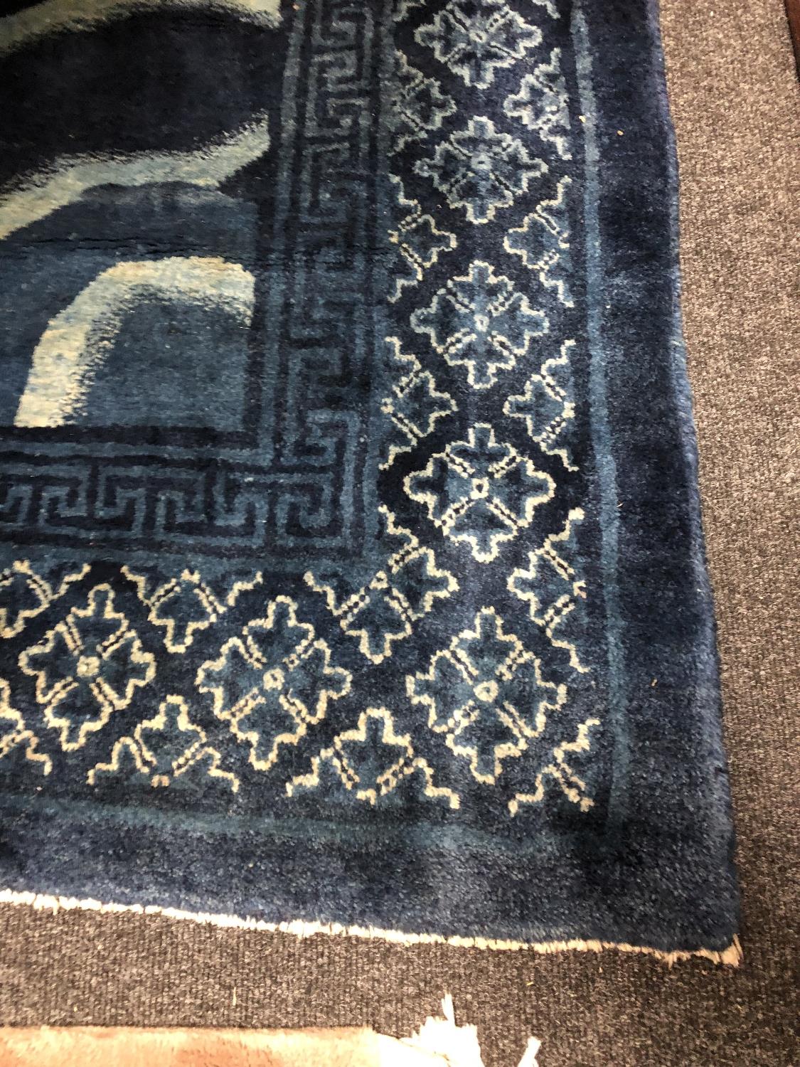 A fringed Chinese rug on blue ground depicting fauna, - Image 3 of 11